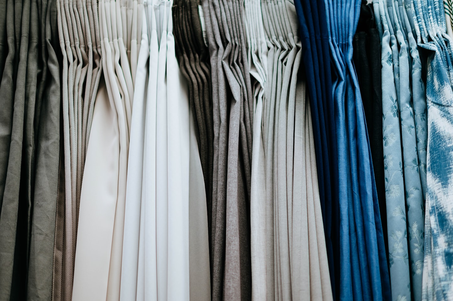 Fabric samples hang neatly in an organized showroom display.